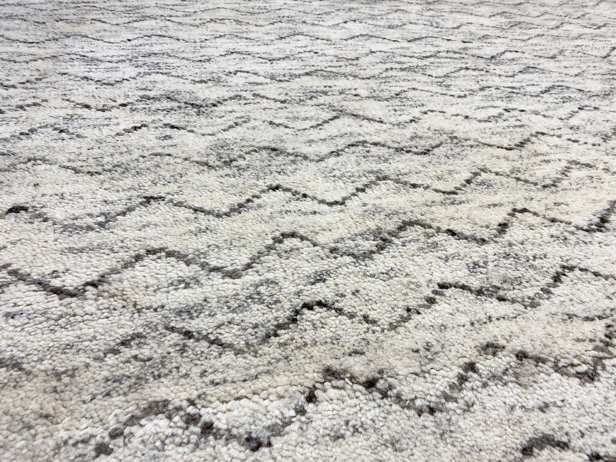 Berber rug close-up: light beige texture with gray zigzag lines
