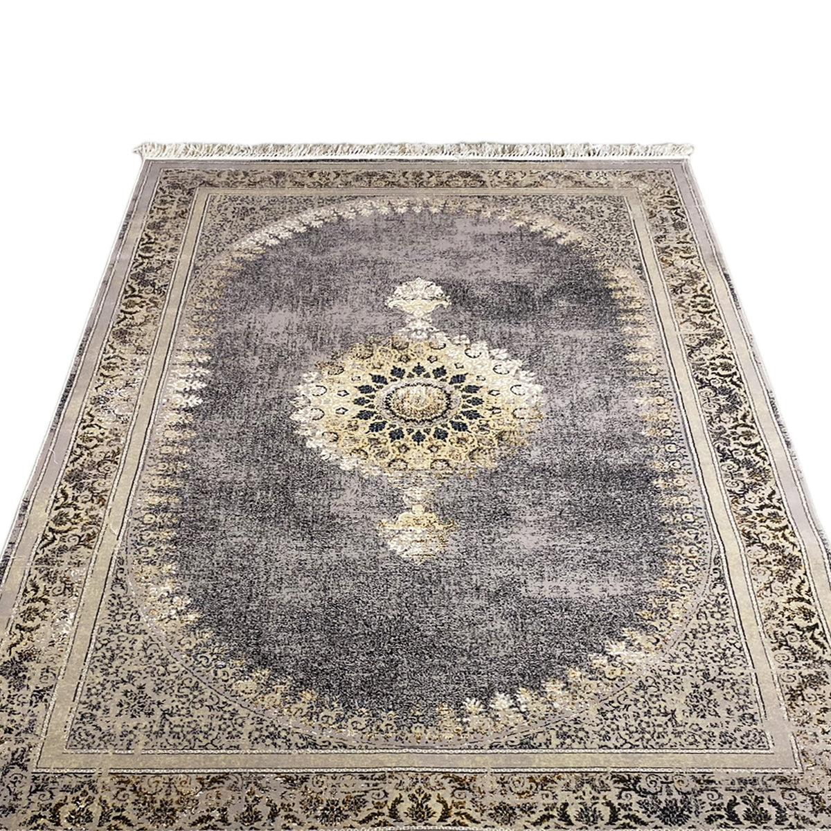Close-up of a medallion rug: dark gray with a gold-colored center and decorative border