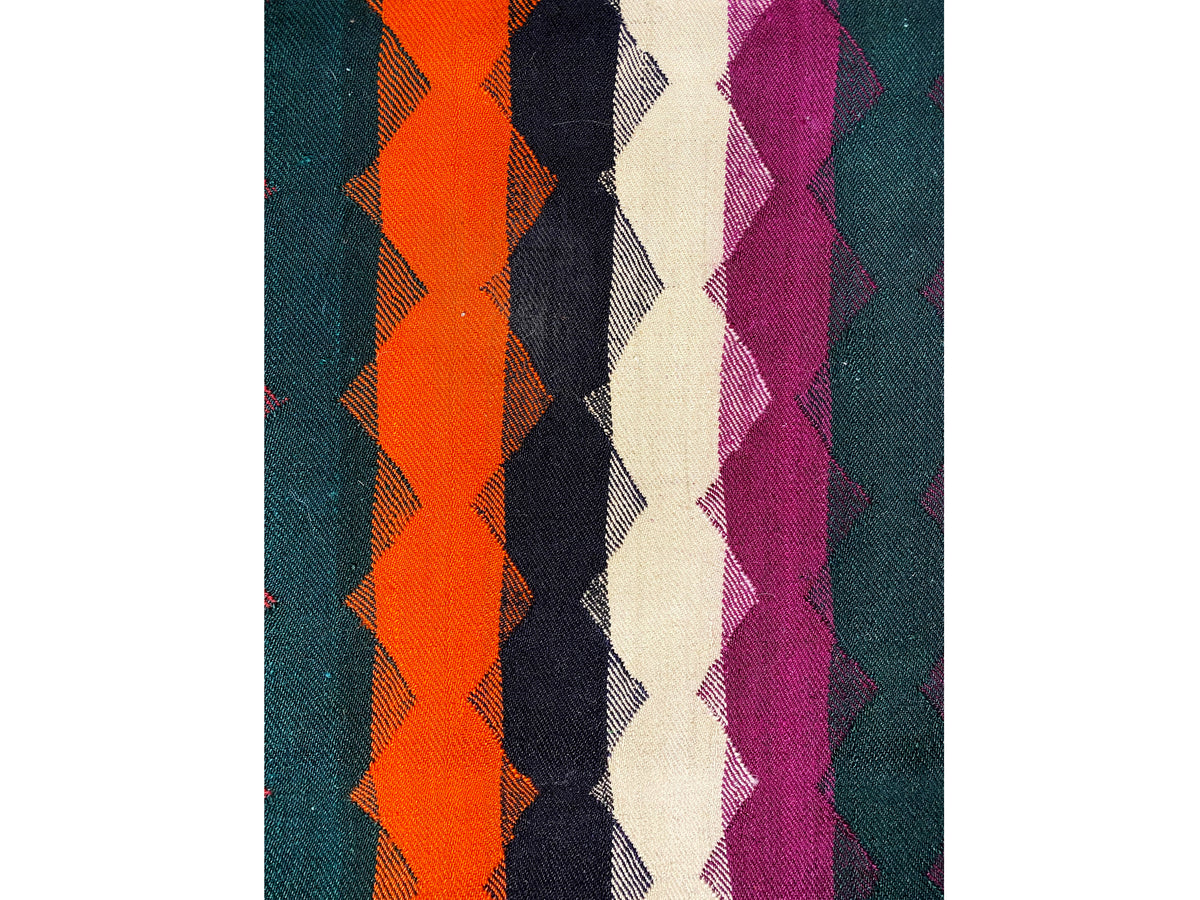 Close-up: Jajim rug with a diamond and stripe pattern in orange, purple, and dark blue