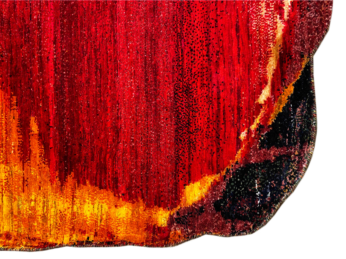 Close-up of a carpet: dense, glossy red pattern with an orange-yellow border and dark dots