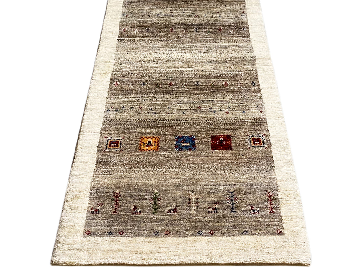 Wide Gabbeh runner rug shown: striped texture, central rows with color accents.