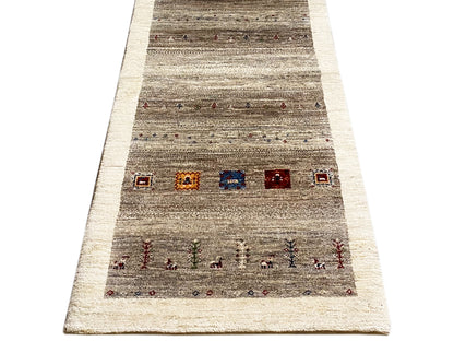 Wide Gabbeh runner rug shown: striped texture, central rows with color accents.