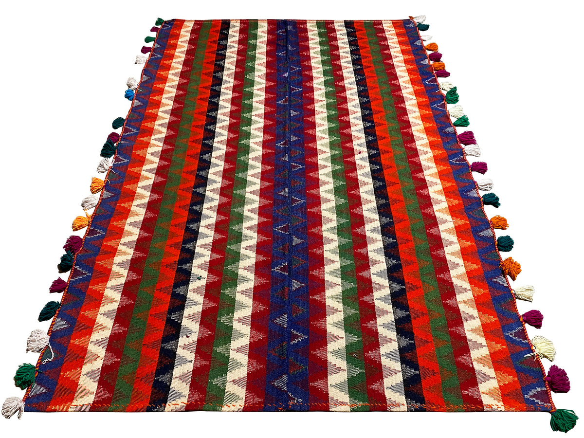 Multicolored striped rug, rectangular, with colorful tassels on the sides