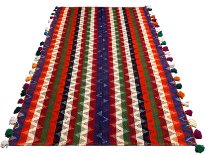 Multicolored striped rug, rectangular, with colorful tassels on the sides