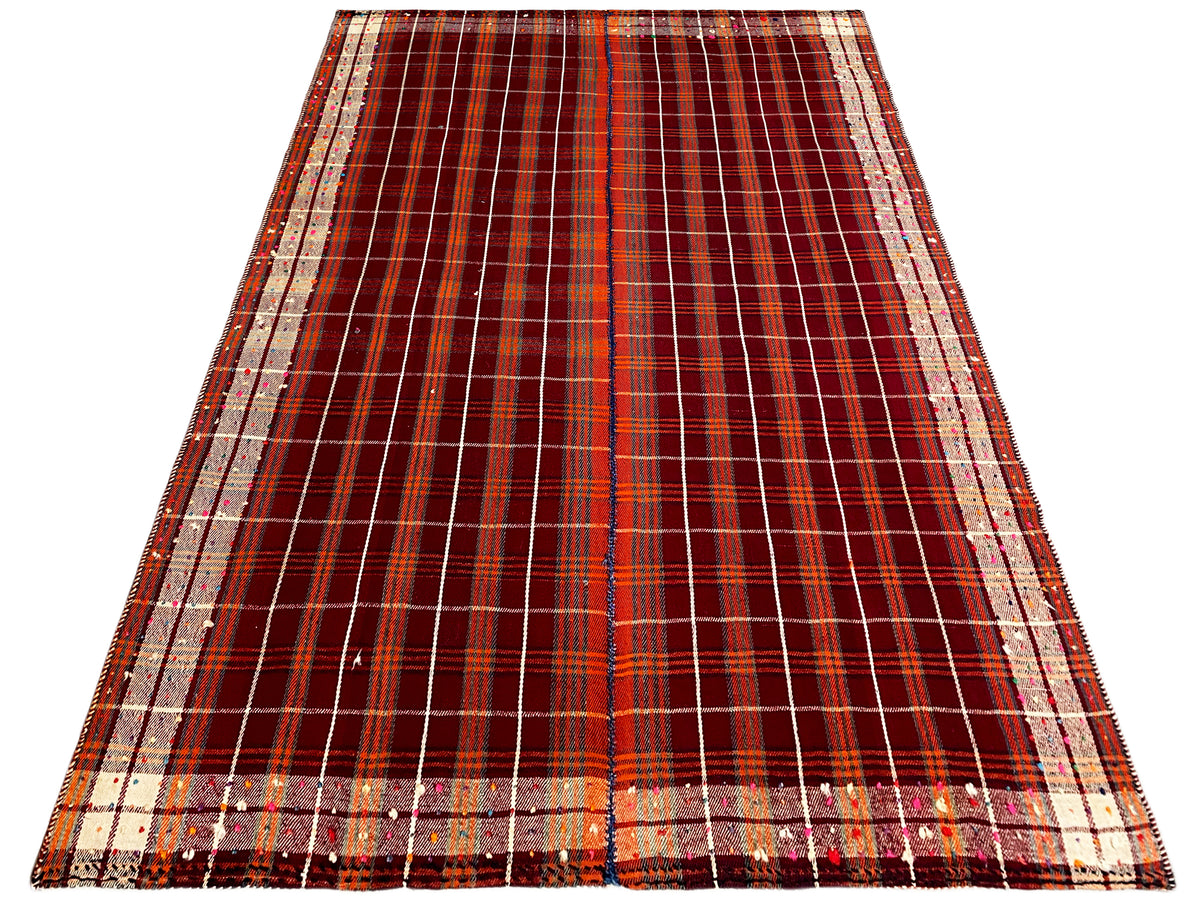 Rectangular rug with a central division and a checkered grid in reddish brown and cream