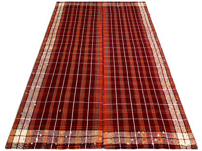 Rectangular rug with a central division and a checkered grid in reddish brown and cream