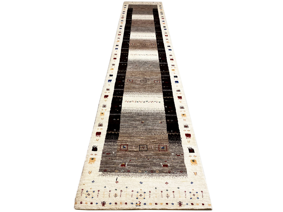 Long Gabbeh runner with dark stripes, light zones, and small colorful ornaments along the edge