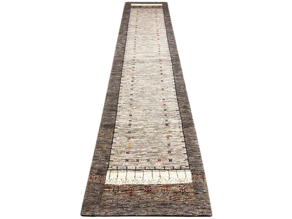 Gabbeh runner rug, straight-on front view, light central area with fine colorful decorations