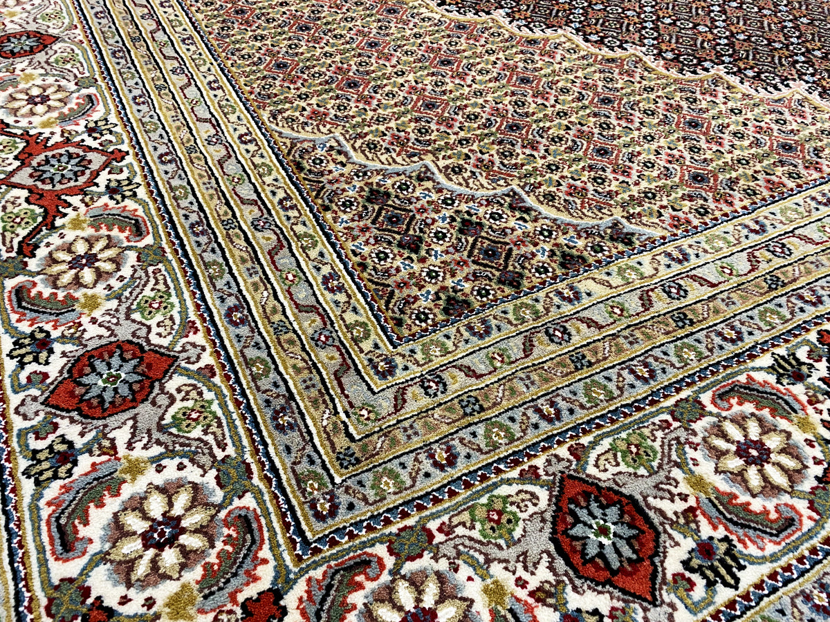 Carpet pattern with ornamental corners and surrounding lines in beige, blue, and red