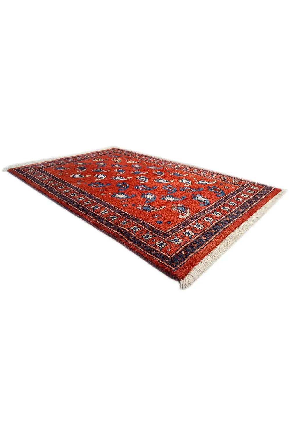 Oriental rug 126×81 cm, red pattern with blue border, photographed at an angle