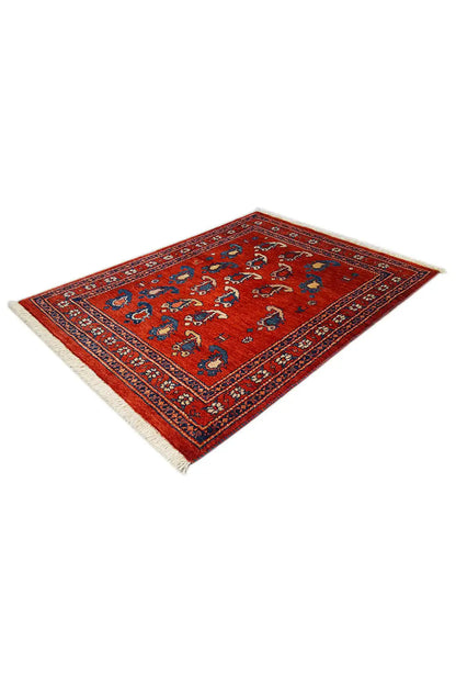 Rug 104x77 cm with a red background and blue ornamental pattern, corner view