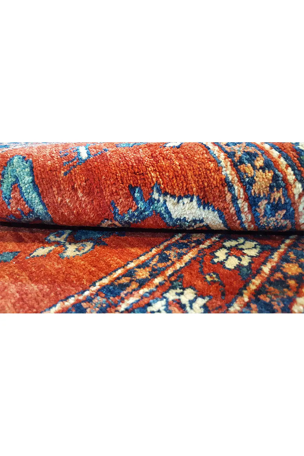 Carpet detail: red pile with a blue patterned stripe and bound edges