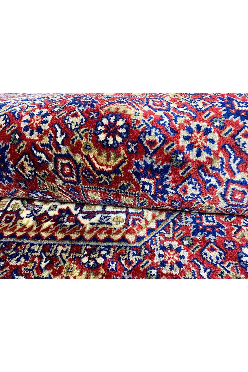 Bidjar rug, folded crosswise, with a blue-red pattern and relief-like texture