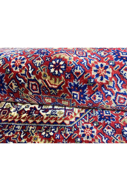 Bidjar rug, folded crosswise, with a blue-red pattern and relief-like texture