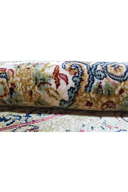 Close-up: rug with a multicolored raised pattern, border trim, and sewn seam