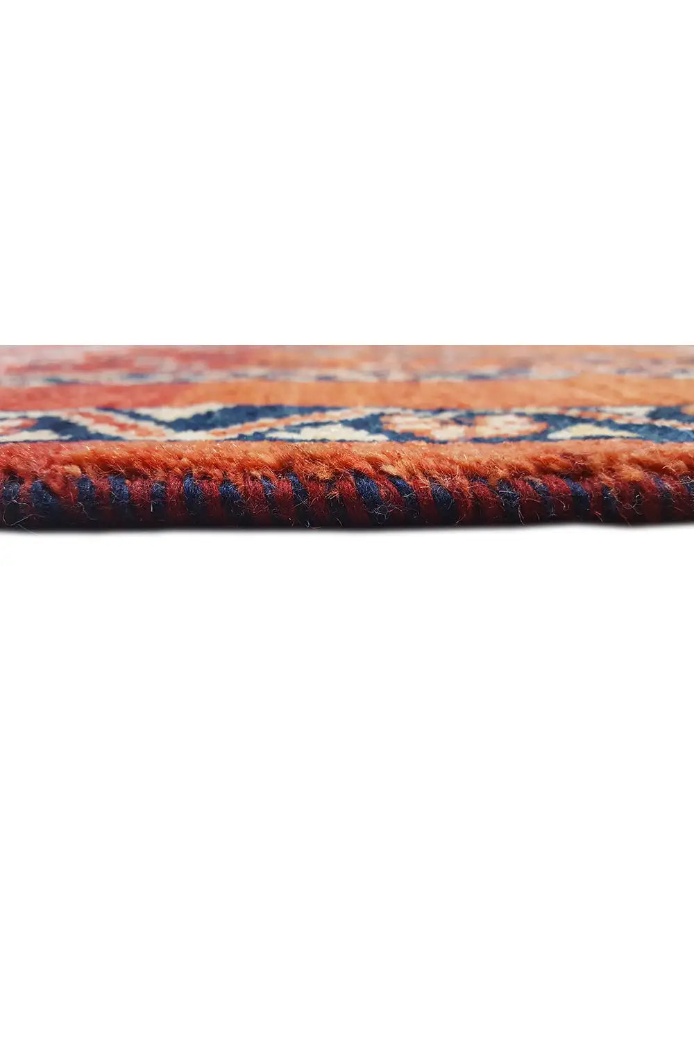 Carpet edge with fringe, reddish-brown pile, and contrasting blue border
