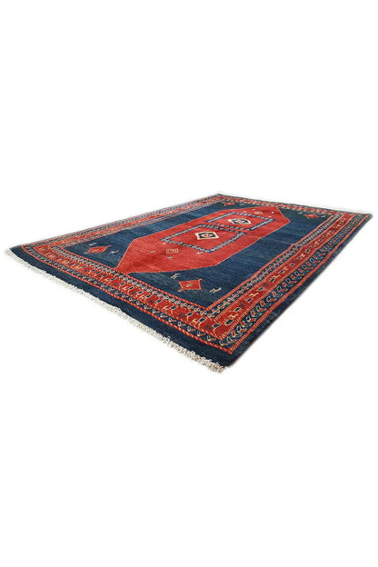 Blue and red rug with central medallions and geometric patterns