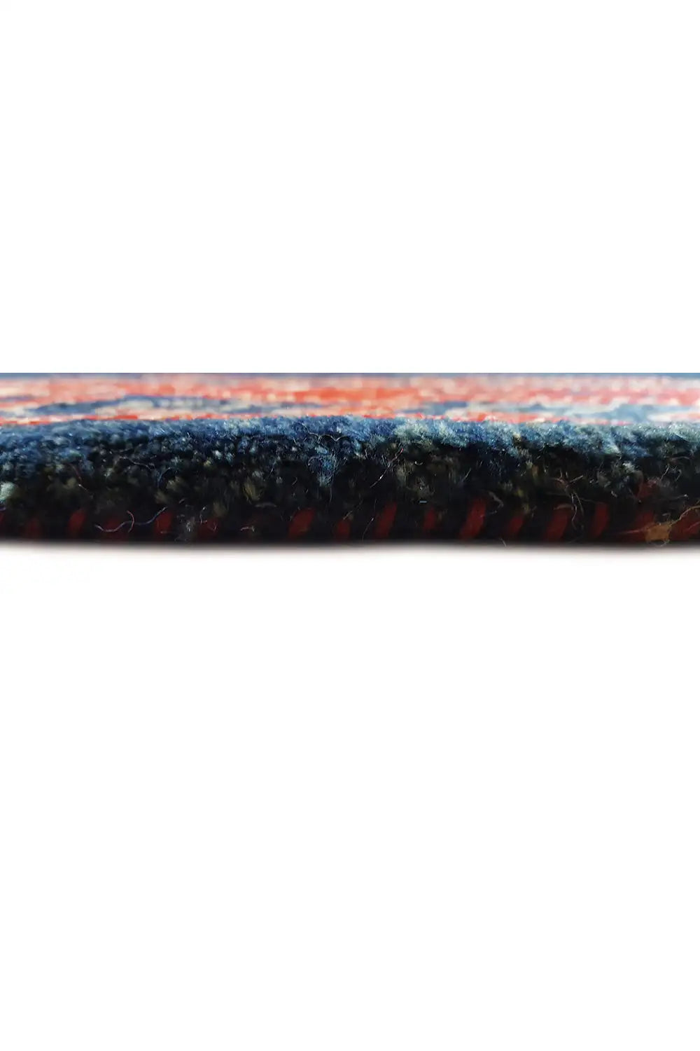 Close-up of the carpet edge with a dense pile structure and multicolored border
