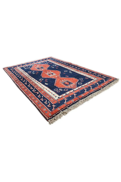 Rug with a diagonal view of a blue-red geometric pattern and fringes