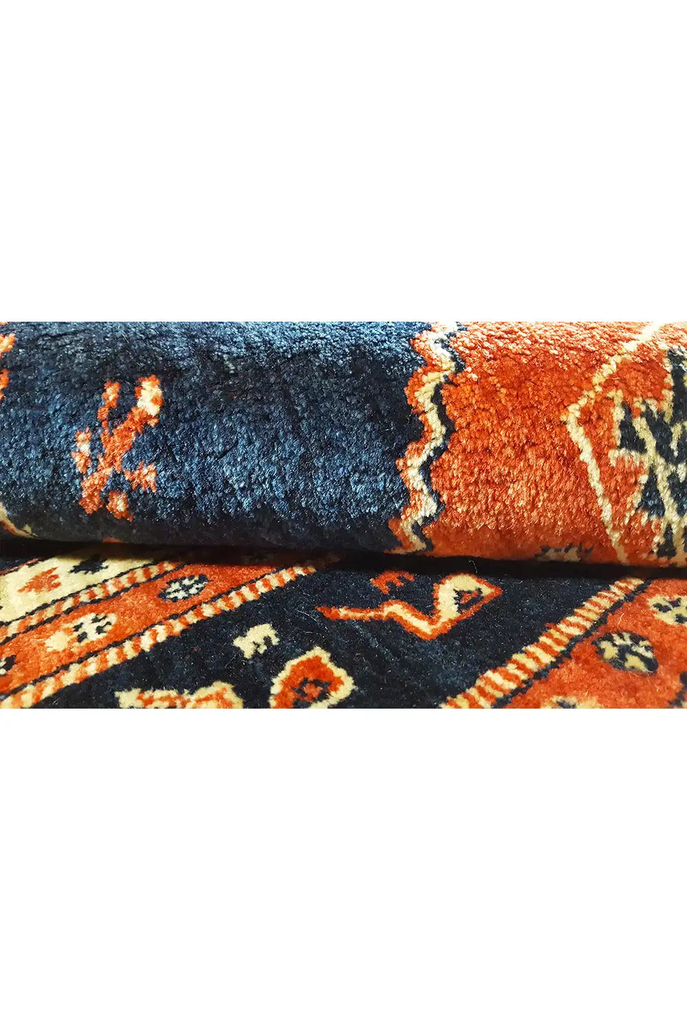 Carpet detail: blue and orange pile band with embellishments