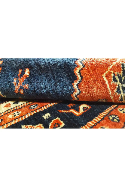 Carpet detail: blue and orange pile band with embellishments
