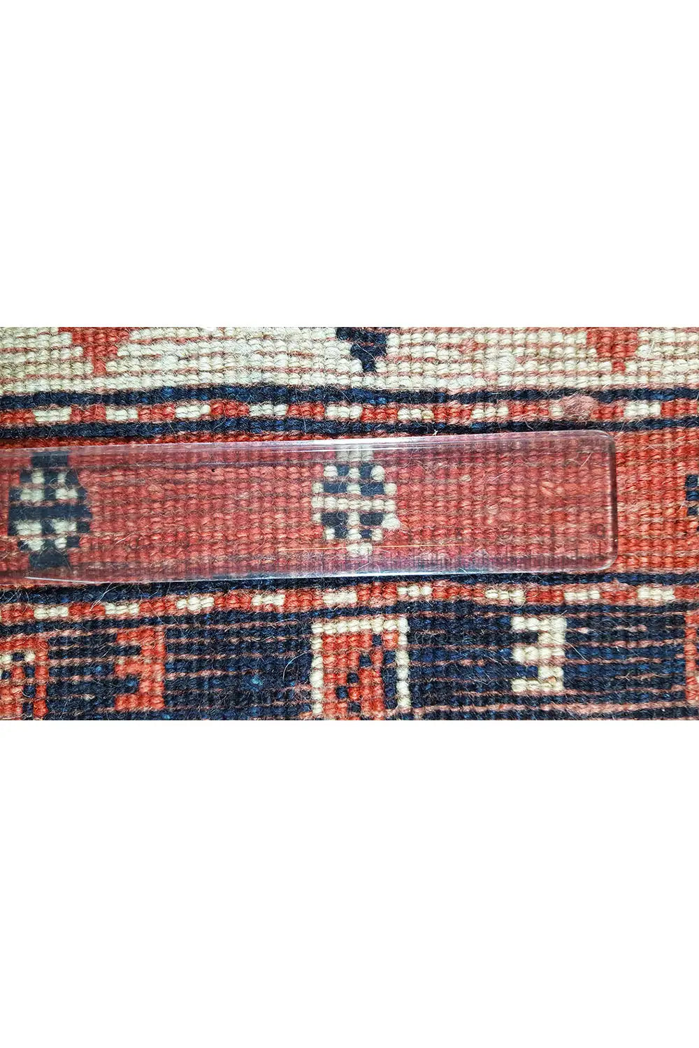Carpet detail: woven border with red and blue fields