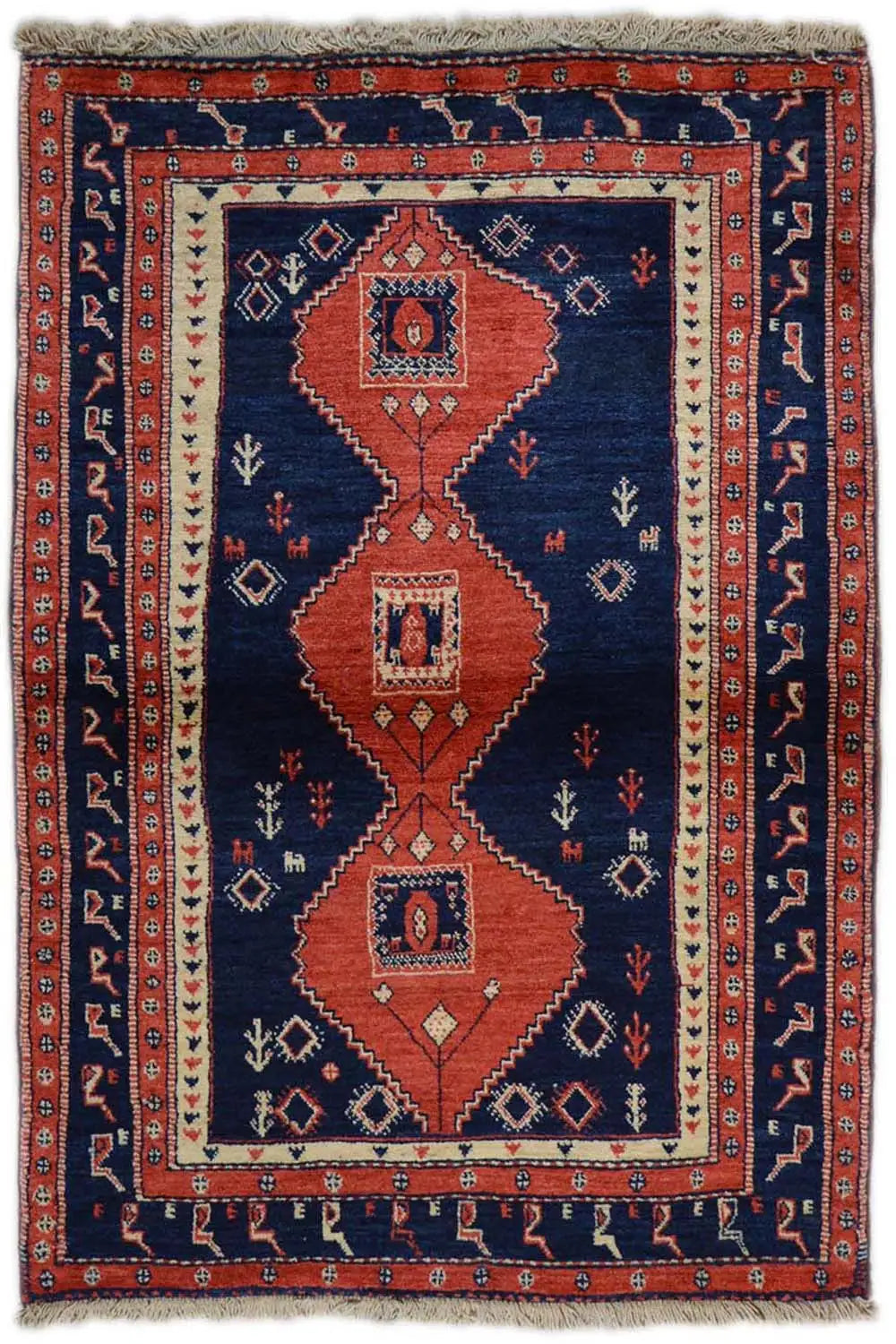 Rectangular rug with a geometric border pattern in blue and rust red