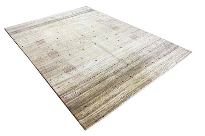 Cream gabbeh rug with beige and gray areas, scattered flecks of color