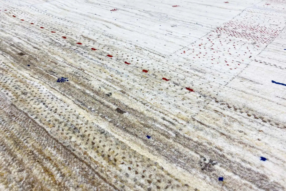 Close-up of a Gabbeh rug: light base with dots and fine lines