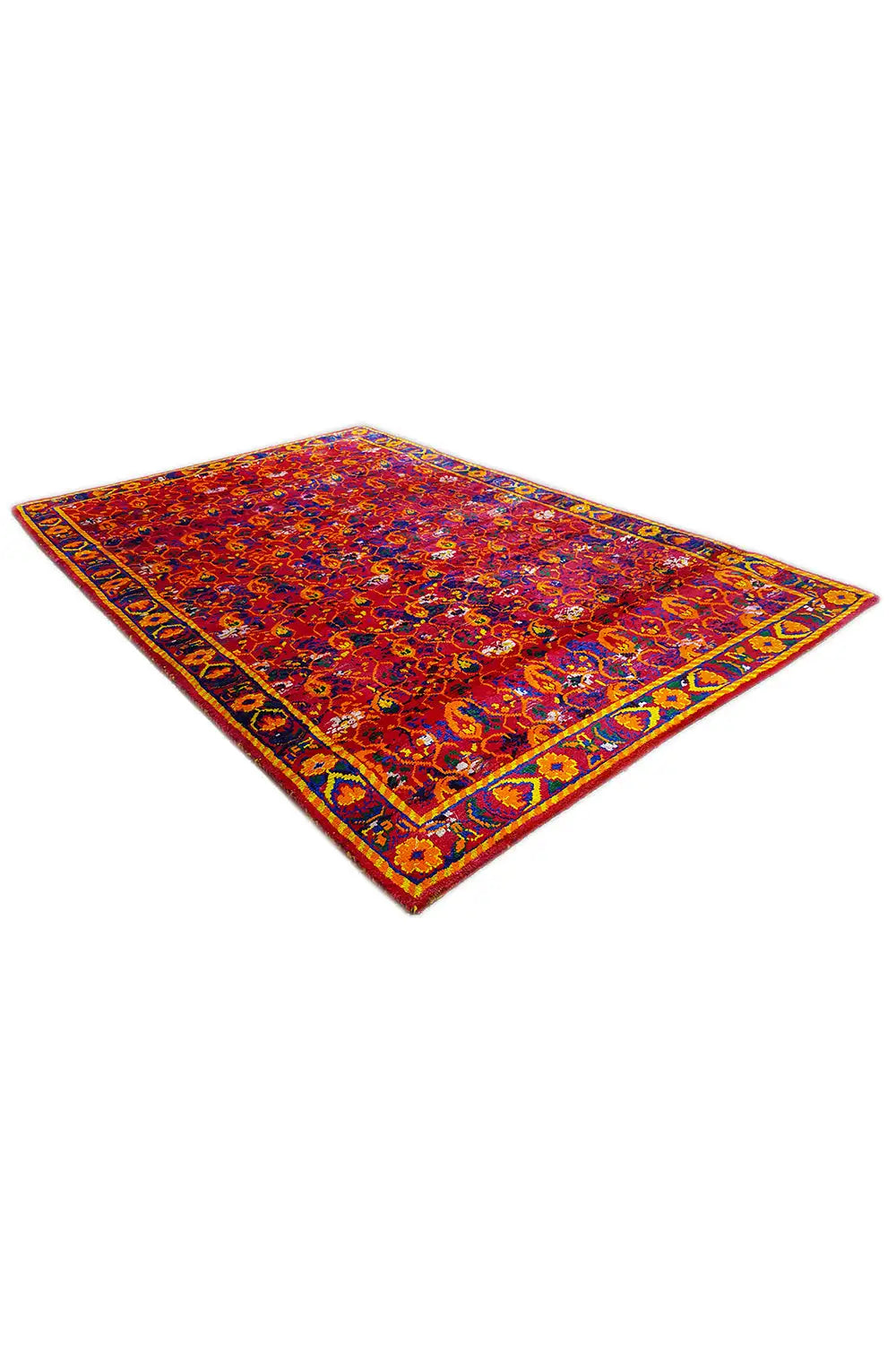 Silk sari rug laid at an angle, bold red-and-blue pattern with a gold border