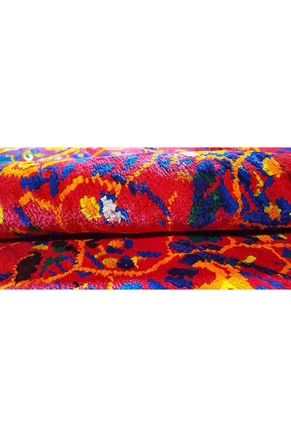 Silk sari rug detail view: floral pattern, colorful fringes along the edge