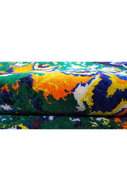 Close-up of a Sari silk rug: colorful pattern of distinct color blocks, braided texture