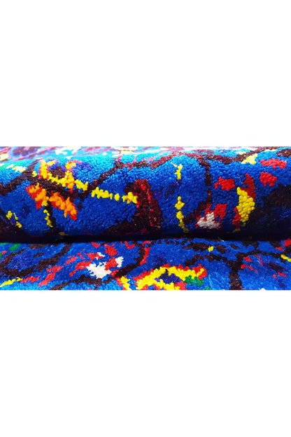 Close-up: blue silk scarf with a colorful pattern and dense texture