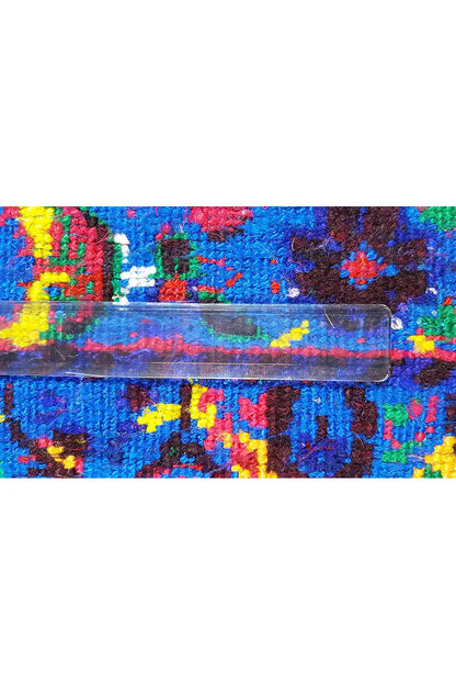 Close-up: Edge detail of a blue silk scarf with colorful ornaments