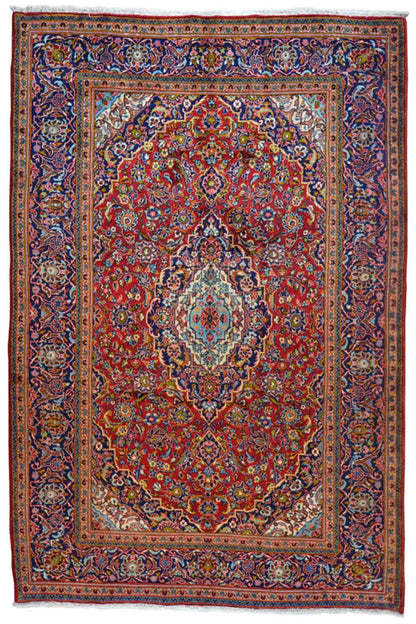 Red and multicolored Oriental rug with a central medallion, rectangular border, and ornamental trim