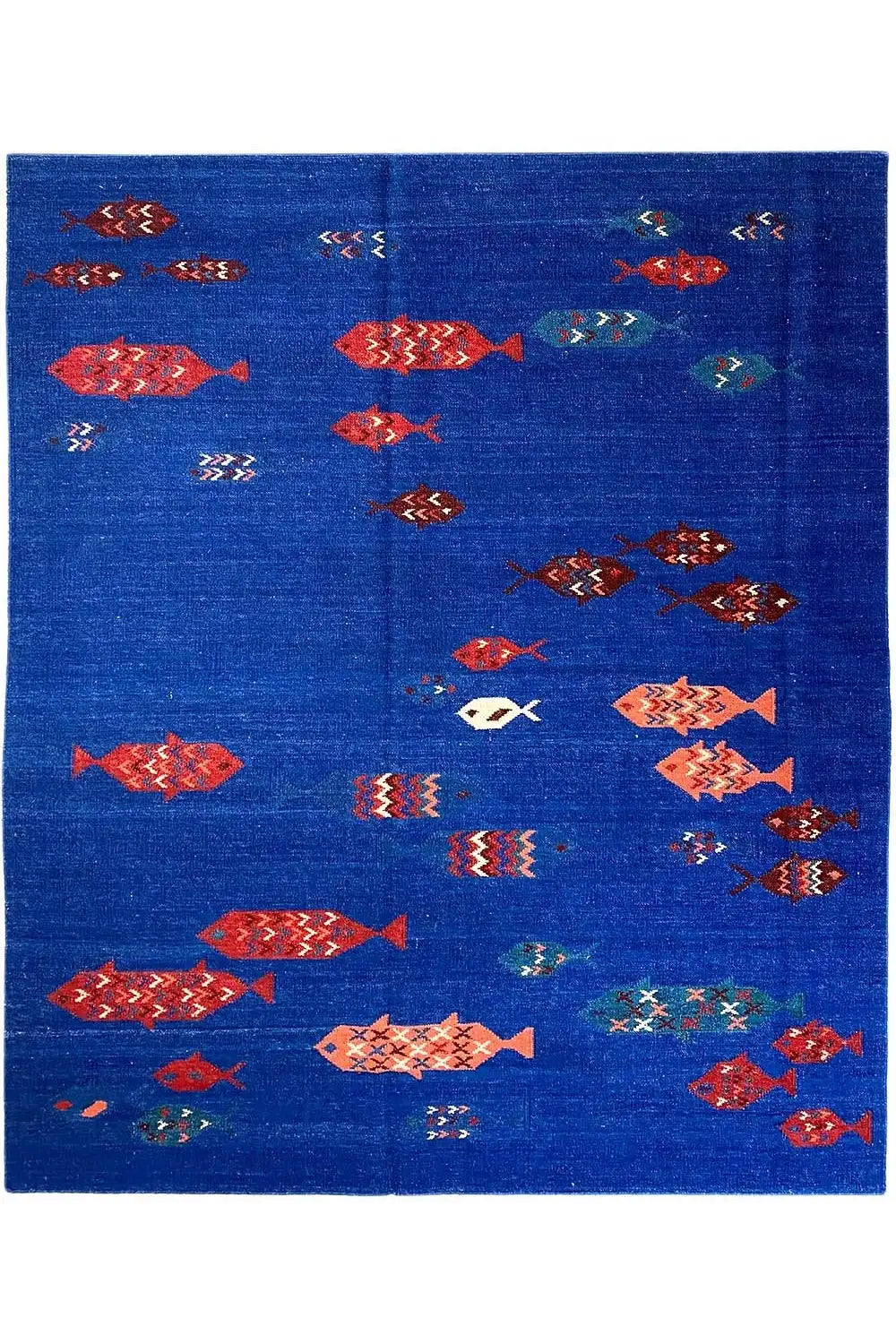 Blue flat-woven rug with many red, orange, and turquoise patterns
