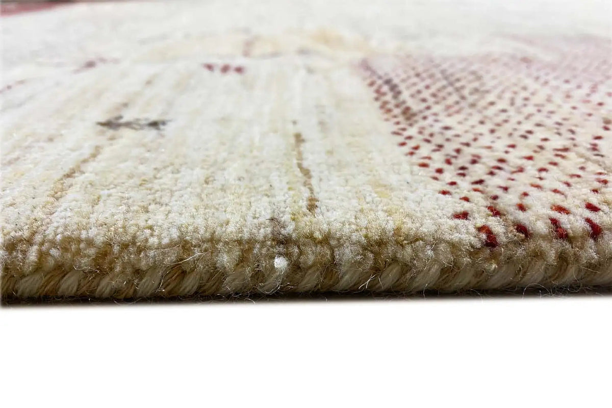 Gabbeh rug edge: beige pile with a dark red stripe, with fringes