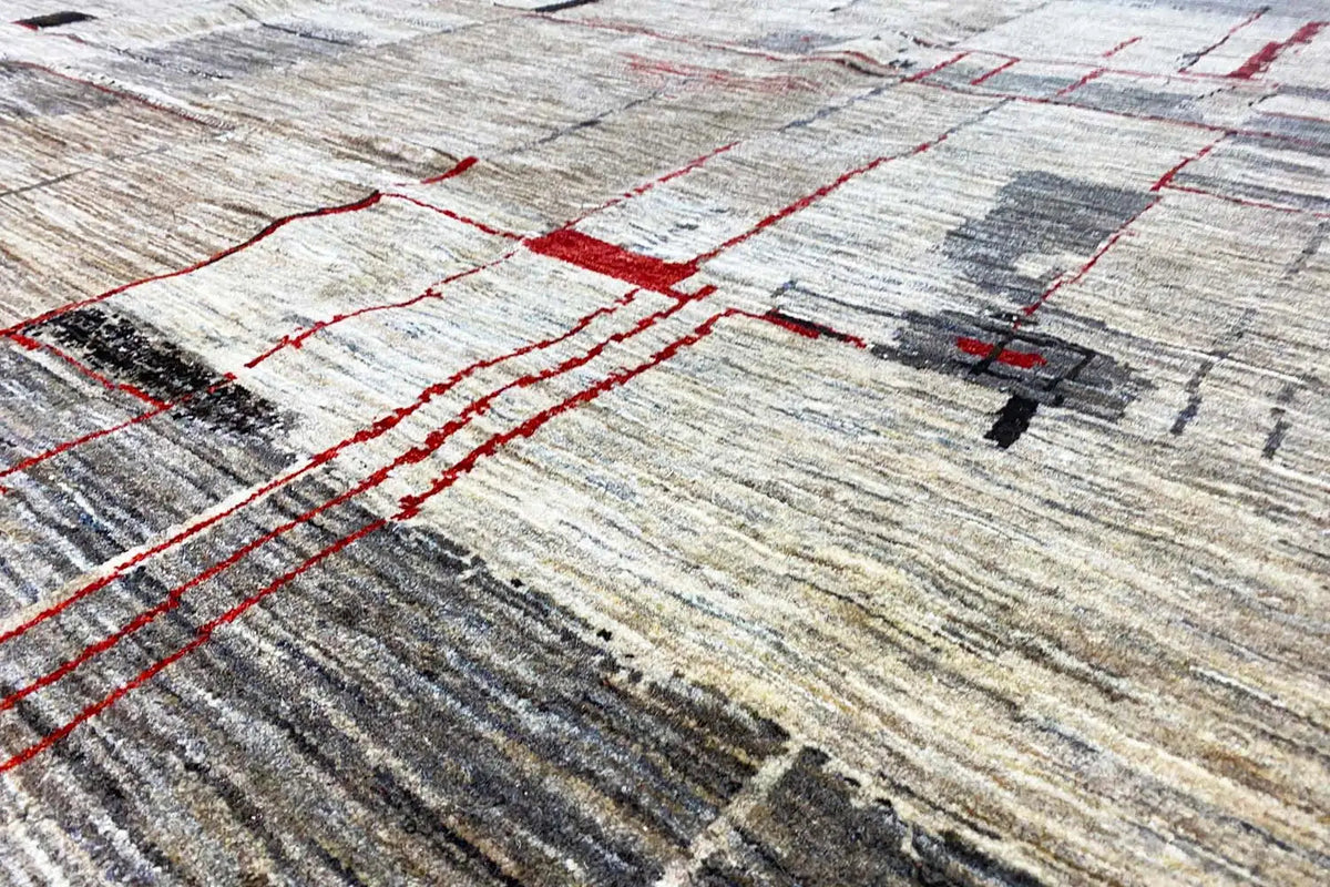 Gabbeh Lori rug detail: red lines on a light, textured pile surface