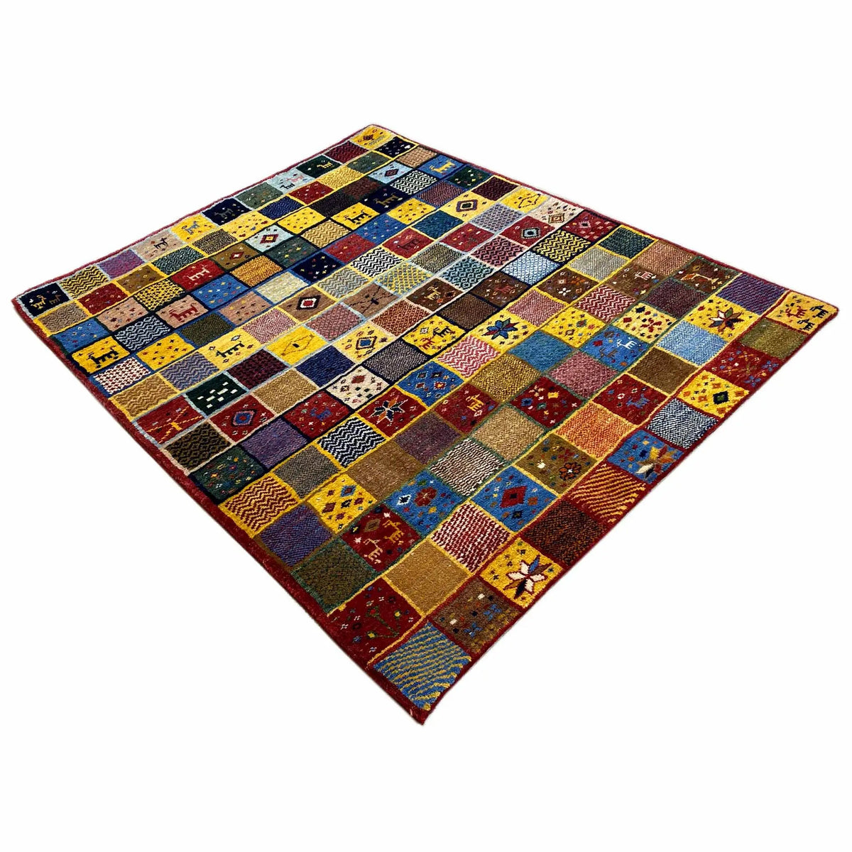 Gabbeh rug (144x125 cm) shown in a diagonal crop: square patchwork pattern, multicolored.
