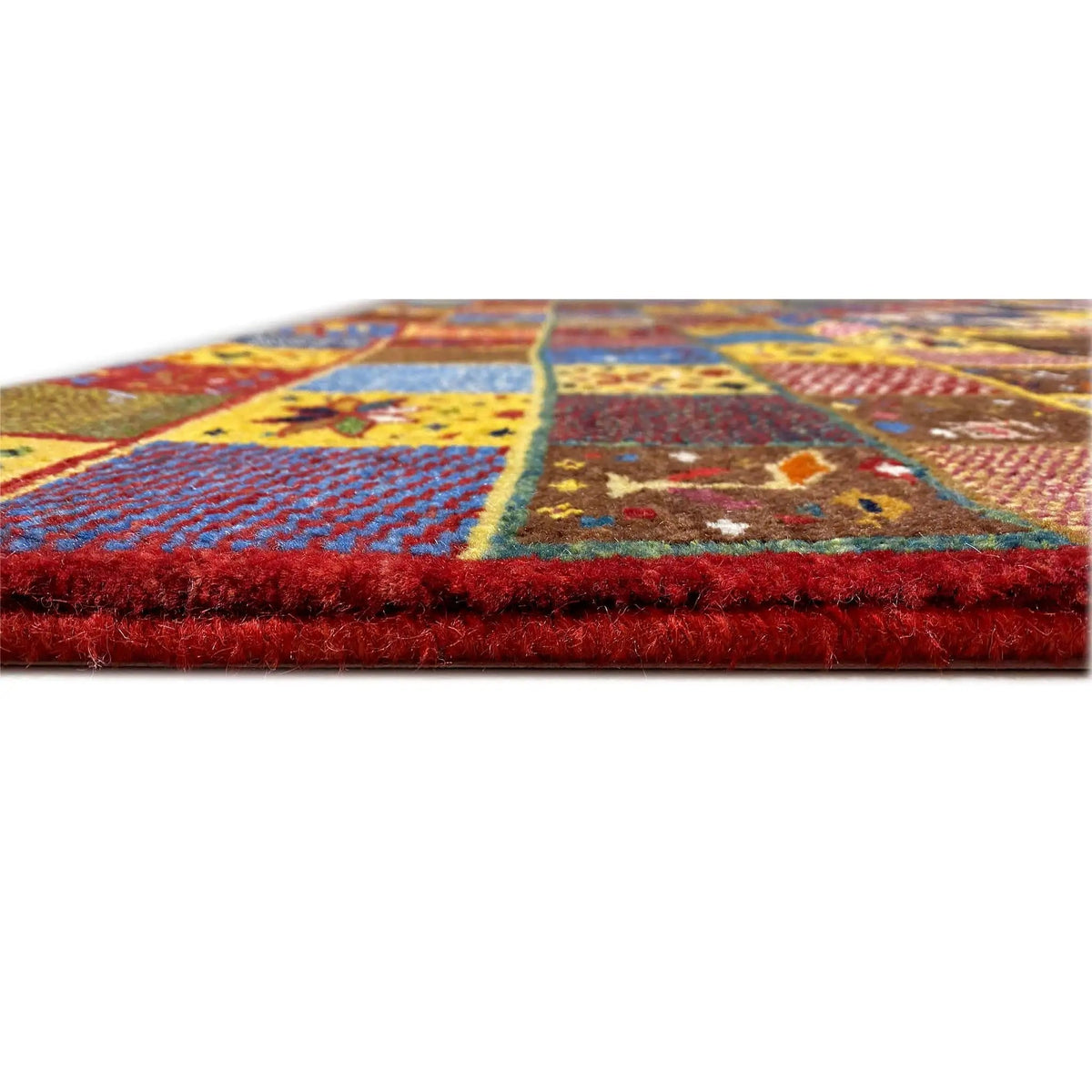 Gabbeh rug (144x125 cm), side view: dense pile, multicolored patchwork pattern.