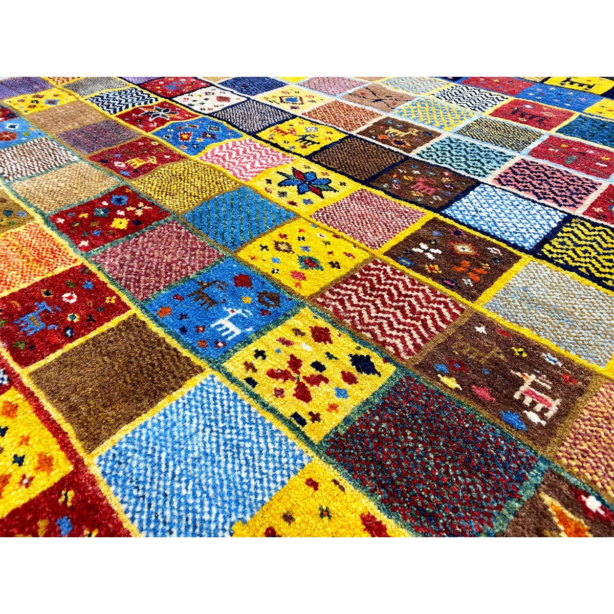Gabbeh rug (144x125 cm) close-up: many colorful squares with small pattern details.