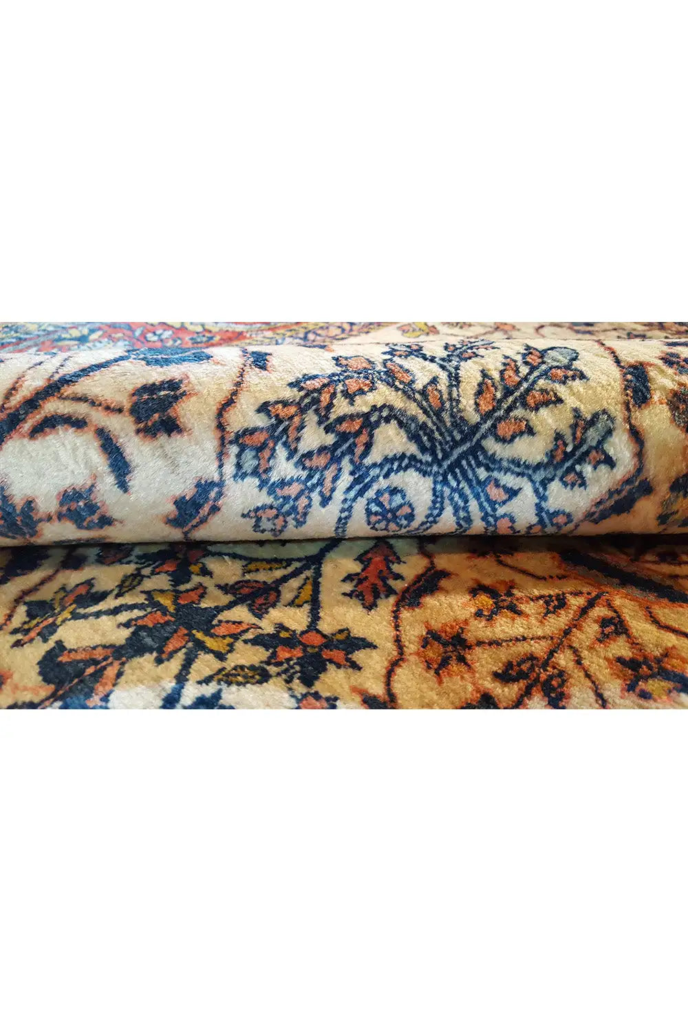 Carpet pattern along the edge: cream, blue, and brown, floral ornaments