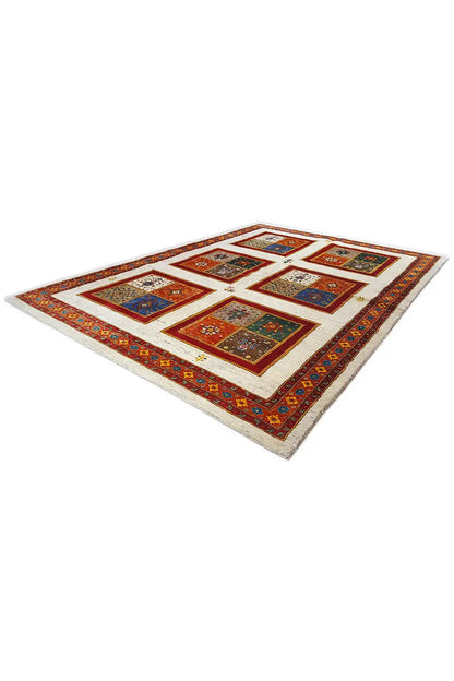 Rug with patchwork squares in shades of red, blue, and green, corner view