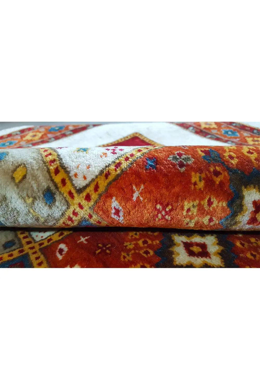 Close-up of a rug edge with a short pile and multicolored pattern along the edge