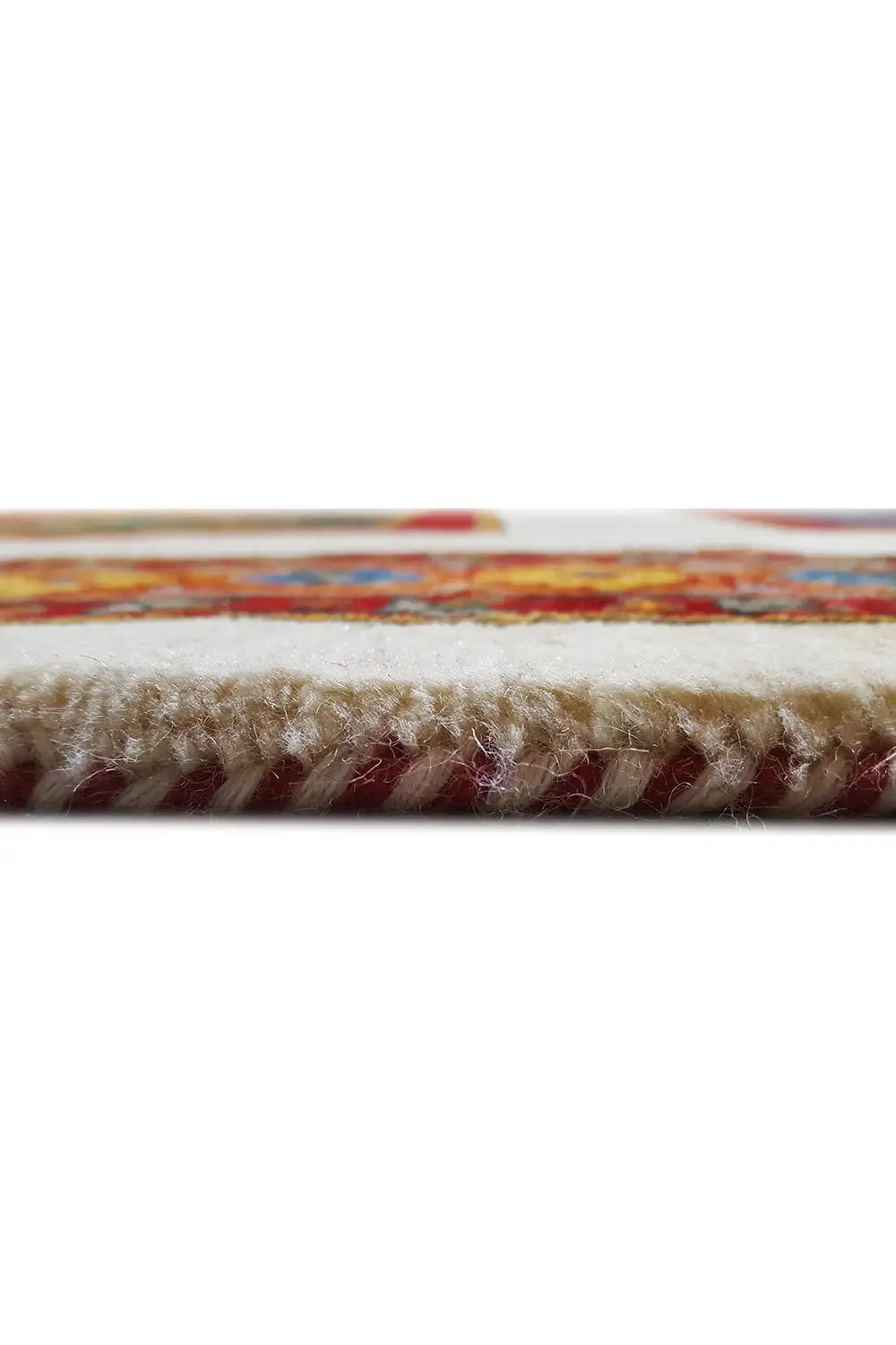 Close-up of the carpet edge with short fringe wrapping and a multicolored border