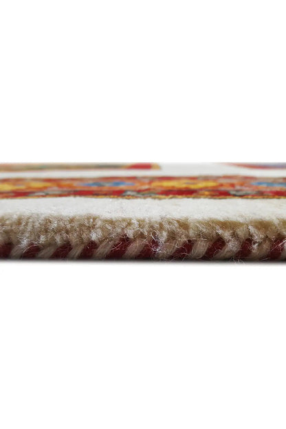 Close-up of the carpet edge with short fringe wrapping and a multicolored border