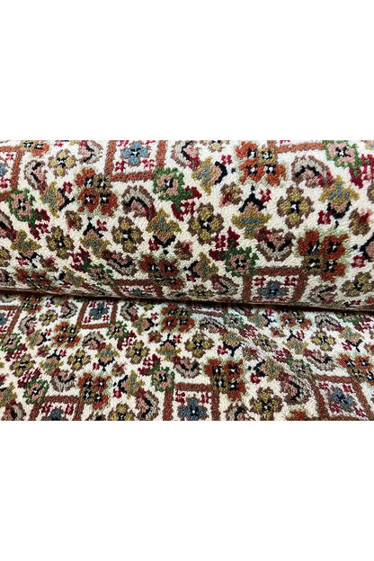 Indo Tabriz rug: Multicolored patterned field with floral border, rectangular