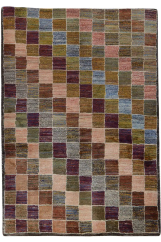 Gabbeh rug in a rectangular shape with a multicolored block pattern on a beige background