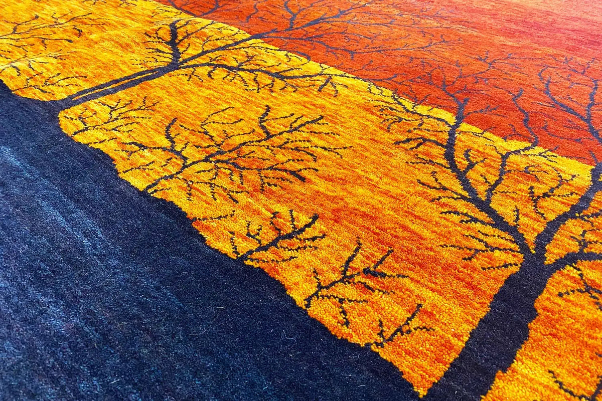 Gabbeh rug detail: yellow treetops against an orange-red sky, dark ground