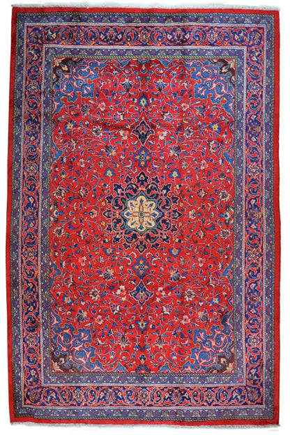 Red carpet field with a blue border, central medallion, and ornaments